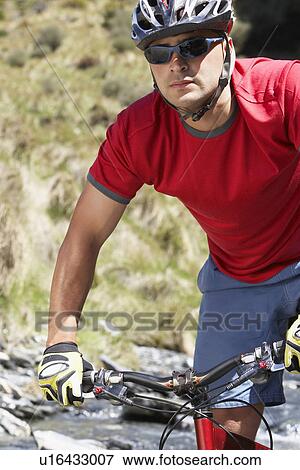 Cyclist in field View Large Photo Image Stock Photo - Cyclist in field. Fotosearch