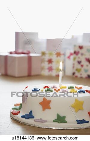 Decorated birthday cake with candle in front of cards in studio View Large Photo Image Stock Photograph - Decorated birthday cake with candle in front of cards in studio. Fotosearch