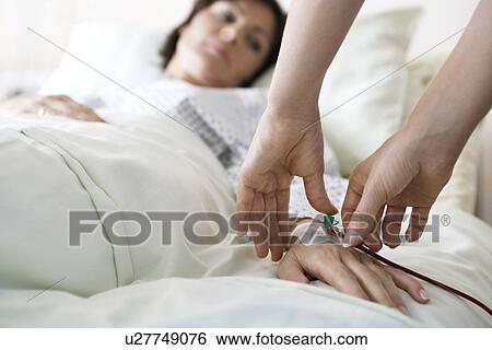 Doctor Attaching Intravenous Tube to hand of Patient close up of hands View Large Photo Image Stock Photograph - Doctor Attaching Intravenous Tube to hand of Patient close up of hands. Fotosearch