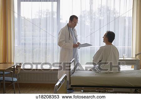 Doctor talking to Patient in Hospital Room back view of patient View Large Photo Image Stock Image - Doctor talking to Patient in Hospital Room back view of patient. Fotosearch