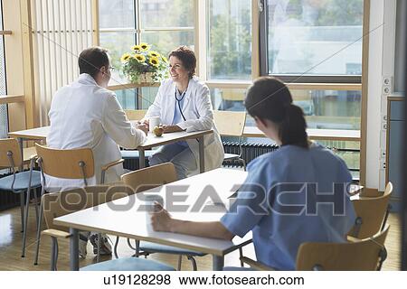 Doctors on Work Break in Cafeteria View Large Photo Image Stock Photo - Doctors on Work Break in Cafeteria. Fotosearch