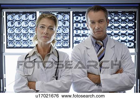 Doctors standing by brain scan images portrait View Large Photo Image Stock Photograph - Doctors standing by brain scan images portrait. Fotosearch