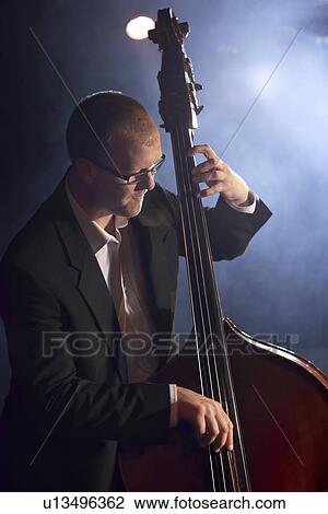 Double bass player on stage portrait View Large Photo Image Stock Image - Double bass player on stage portrait. Fotosearch