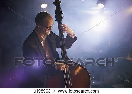 Double bass player on stage portrait View Large Photo Image Stock Photo - Double bass player on stage portrait. Fotosearch