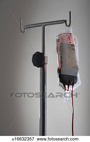 Drip bag with blood on stand against white background View Large Photo Image Stock Photo - Drip bag with blood on stand against white background. Fotosearch