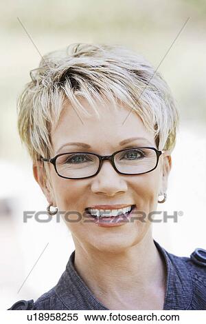 Elegant mature woman wearing glasses portrait View Large Photo Image Stock Photography - Elegant mature woman wearing glasses portrait. Fotosearch