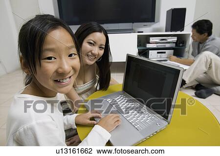Family in Living Room Using Laptop and Home Theatre System portrait View Large Photo Image Stock Image - Family in Living Room Using Laptop and Home Theatre System portrait. Fotosearch