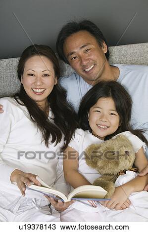 Family Reading in Bed Together portrait View Large Photo Image Stock Image - Family Reading in Bed Together portrait. Fotosearch