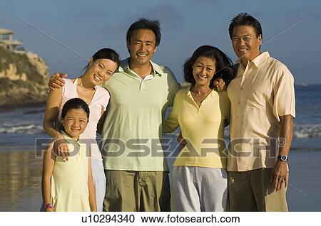 Family with girl (7-9) on beach (portrait) View Large Photo Image Stock Image - Family with girl (7-9) on beach (portrait). Fotosearch
