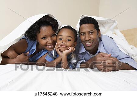 Family with son (3-6) lying underneath sheet portrait View Large Photo Image Stock Photo - Family with son (3-6) lying underneath sheet portrait. Fotosearch