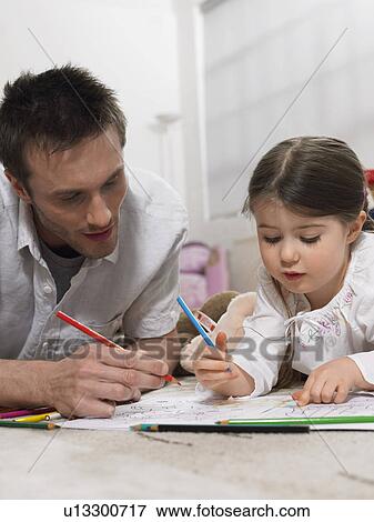 Father and daughter (3-4) colouring in book on floor View Large Photo Image Stock Photo - Father and daughter (3-4) colouring in book on floor. Fotosearch