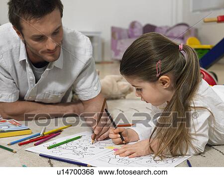 Father and daughter (3-4) colouring in book on floor View Large Photo Image Stock Photo - Father and daughter (3-4) colouring in book on floor. Fotosearch