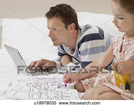 Father and daughter drawing and using laptop on bed View Large Photo Image Stock Photography - Father and daughter drawing and using laptop on bed. Fotosearch