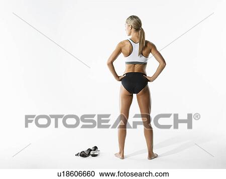Female athlete standing back view View Large Photo Image Stock Image - Female athlete standing back view. Fotosearch