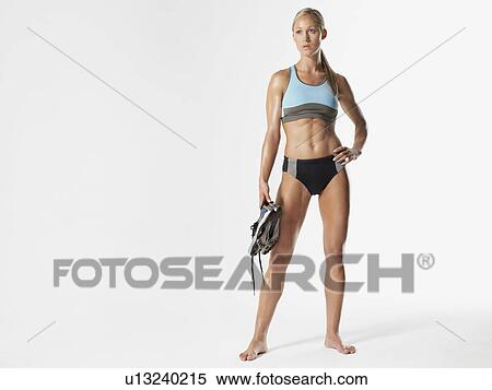 Female athlete standing holding shoes portrait View Large Photo Image Stock Photography - Female athlete standing holding shoes portrait. Fotosearch