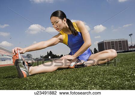 Female athlete stretching View Large Photo Image Stock Image - Female athlete stretching. Fotosearch