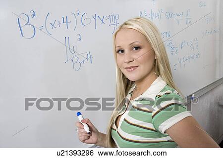 Female student writing maths equations on whiteboard View Large Photo Image Stock Photograph - Female student writing maths equations on whiteboard. Fotosearch