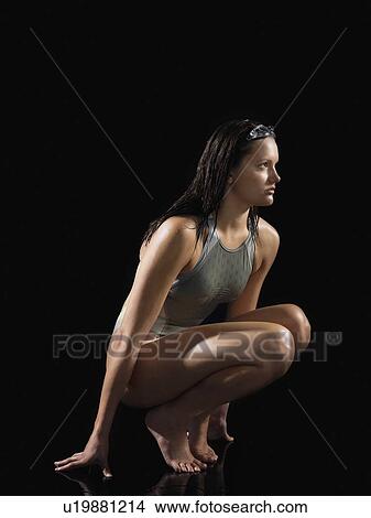 Female swimmer crouching side view View Large Photo Image Picture - Female swimmer crouching side view. Fotosearch