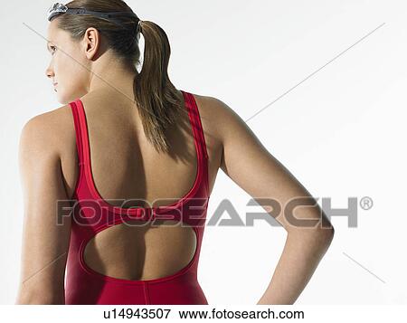 Stock Photo - Female swimmer standing back view. Fotosearch