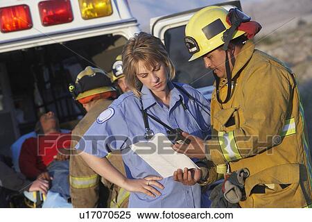 Fire fighters and paramedics assisting injured man View Large Photo Image Stock Photography - Fire fighters and paramedics assisting injured man. Fotosearch