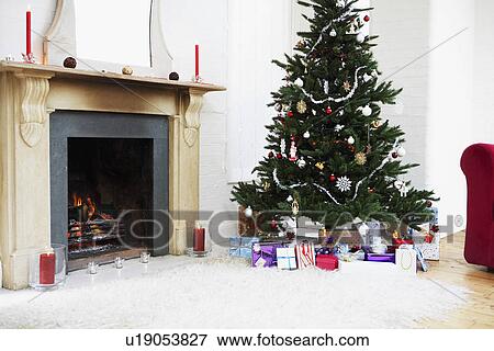Stock Photo - Fireplace and Christmas Tree with presents. Fotosearch