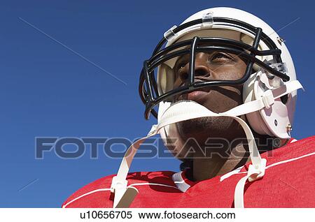 Football Player wearing helmet on outside low angle view close-up (close-up) (low angle view) View Large Photo Image Stock Photography - Football Player wearing helmet on outside low angle view close-up (close-up) (low angle view). Fotosearch