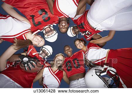 Football Players and cheerleaders in Huddle view from below (view from below) View Large Photo Image Stock Photo - Football Players and cheerleaders in Huddle view from below (view from below). Fotosearch