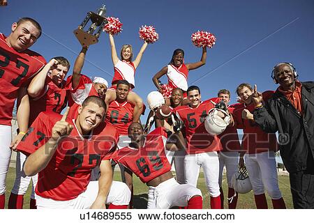 Football players cheerleaders and coach hoisting trophy portrait View Large Photo Image Stock Photography - Football players cheerleaders and coach hoisting trophy portrait. Fotosearch