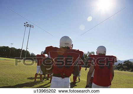 Football Players walking onto Field back view View Large Photo Image Stock Image - Football Players walking onto Field back view. Fotosearch