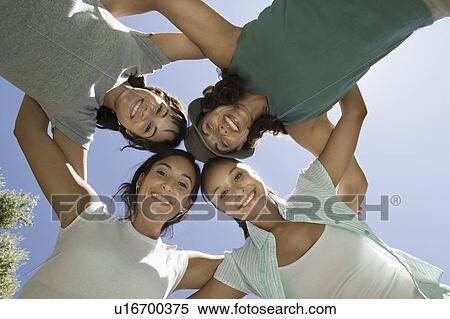 Four women in huddle view from below. View Large Photo Image Stock Photography - Four women in huddle view from below.. Fotosearch