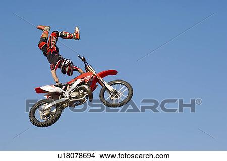 Freestyle motocross racer performing stunt in air View Large Photo Image Picture - Freestyle motocross racer performing stunt in air. Fotosearch