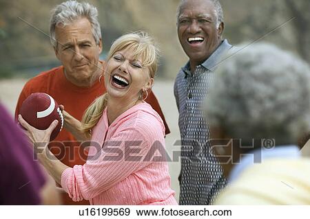 Friends playing American football outdoors View Large Photo Image Stock Photo - Friends playing American football outdoors. Fotosearch