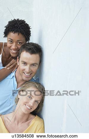 Friends posing together against wall portrait View Large Photo Image Stock Photo - Friends posing together against wall portrait. Fotosearch
