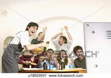 Friends watching TV and celebrating View Large Photo Image Stock Photo - Friends watching TV and celebrating. Fotosearch