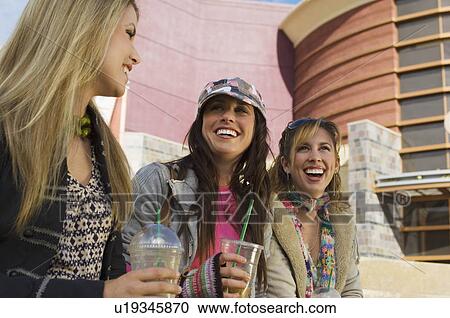 Friends with drinks in street View Large Photo Image Stock Image - Friends with drinks in street. Fotosearch