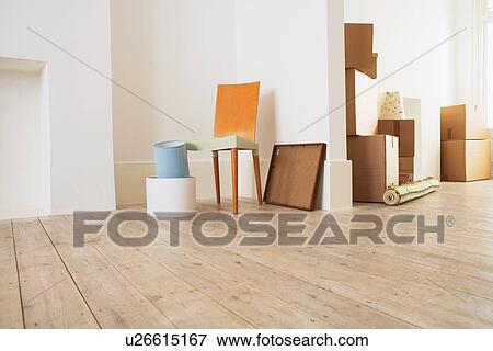 Stock Photo - Furniture and Cardboard Boxes in New House. Fotosearch