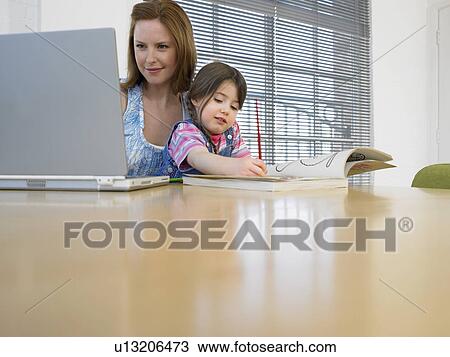 Girl (3-4) colouring in book beside mother using laptop in home View Large Photo Image Stock Image - Girl (3-4) colouring in book beside mother using laptop in home. Fotosearch