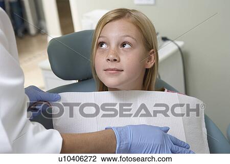 Stock Image - Girl (7-10) at dentists (close-up). Fotosearch