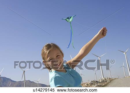 Girl (7-9) with kite on wind farm portrait View Large Photo Image Stock Photography - Girl (7-9) with kite on wind farm portrait. Fotosearch