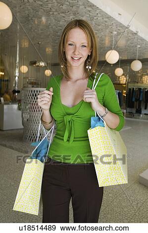 Girl Holding Shopping Bags in Boutique portrait View Large Photo Image Stock Photo - Girl Holding Shopping Bags in Boutique portrait. Fotosearch