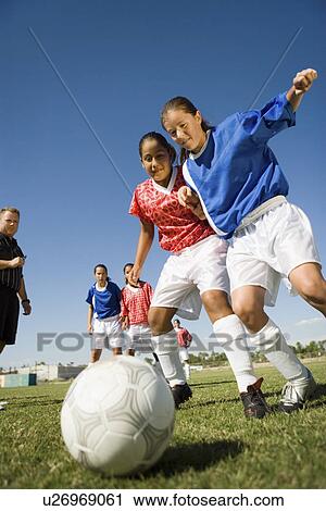 Girls (13-17) playing soccer low angle view View Large Photo Image Stock Image - Girls (13-17) playing soccer low angle view. Fotosearch