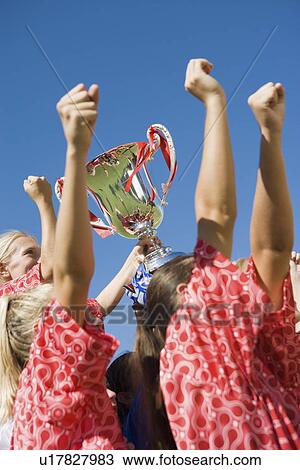 Girls' soccer team (13-17) holding trophy side view View Large Photo Image Stock Image - Girls' soccer team (13-17) holding trophy side view. Fotosearch