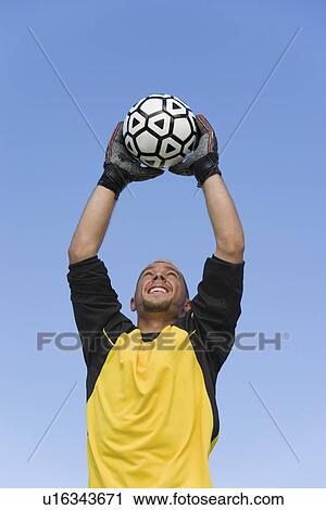 Goalkeeper catching soccer ball portrait View Large Photo Image Stock Image - Goalkeeper catching soccer ball portrait. Fotosearch
