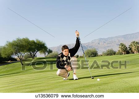 Golfer lining up putt View Large Photo Image Stock Photo - Golfer lining up putt. Fotosearch