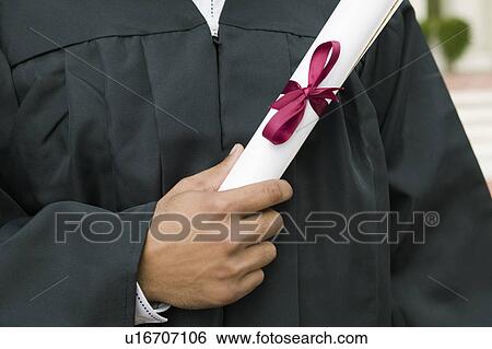 Stock Photograph - Graduate Holding Diploma mid section. Fotosearch