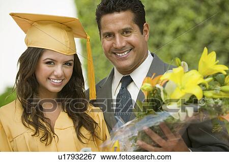 Stock Photo - Graduate with flowers and father outside portrait. Fotosearch