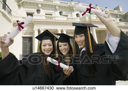 Graduates hoisting diplomas outside university portrait View Large Photo Image Stock Image - Graduates hoisting diplomas outside university portrait. Fotosearch