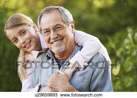 Stock Image - Grandfather and Granddaughter in back yard portrait. Fotosearch