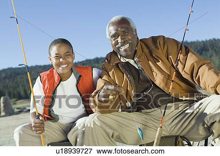 Stock Photo - Grandfather and grandson fishing (portrait). Fotosearch