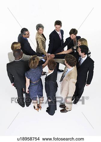 Picture - Group of Businesspeople in a circle joining hands. Fotosearch